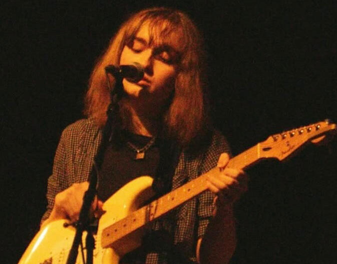 Brook Hallet playing the guitar